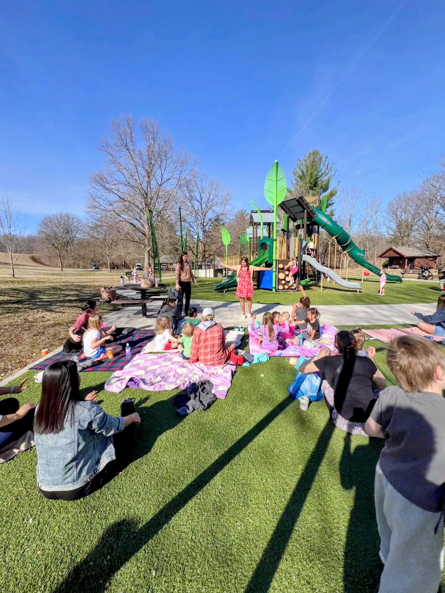 Children gathered outdoors for a reading event featuring The Garden In Me